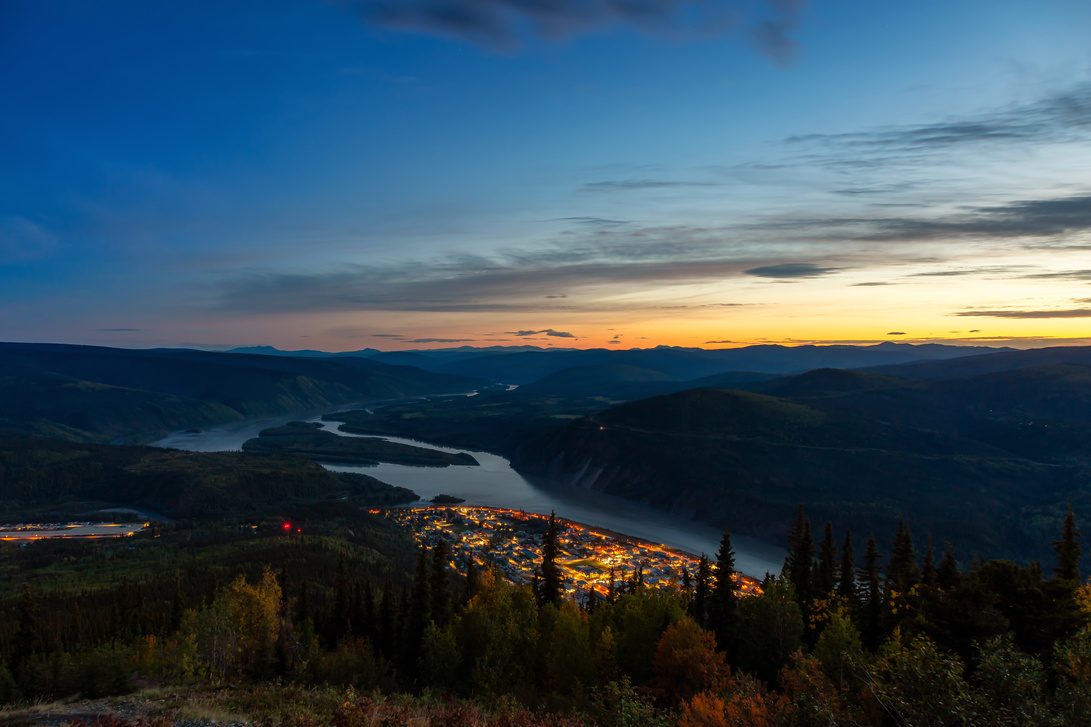 sunset over a small town near a lake