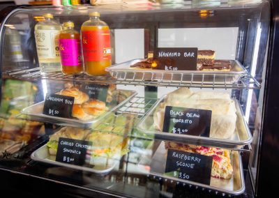 various pastries and bottled drinks displayed in a chiller