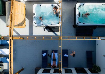 people inside two Jacuzzi tubs