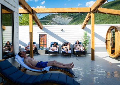 people relaxing on chaise lounges