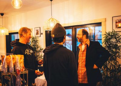 three men having a conversation