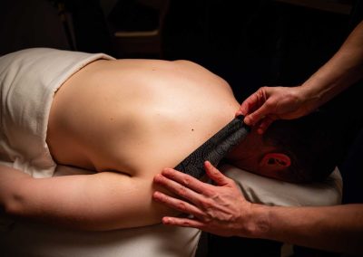 piece of cloth being placed on a person's shoulders