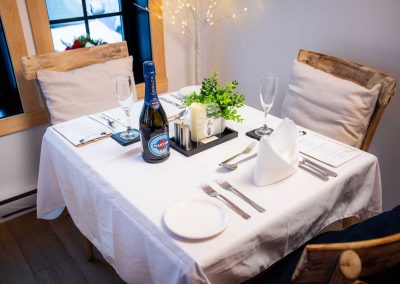 bottle of martini set on a table for two